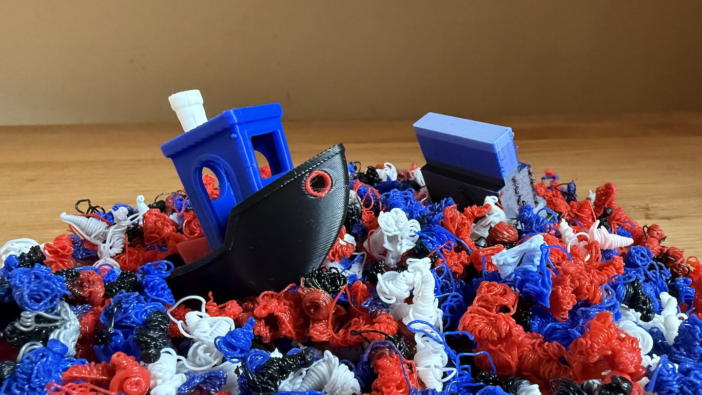 A multi-colour Benchy sailing on a sea of poop